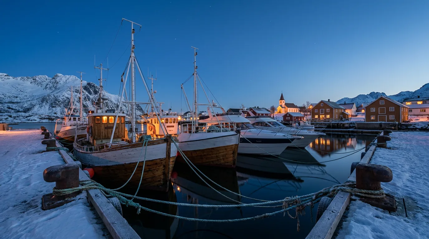 Whale watching vessels from different operators moored side by side in a Northern Norway harbour at dusk